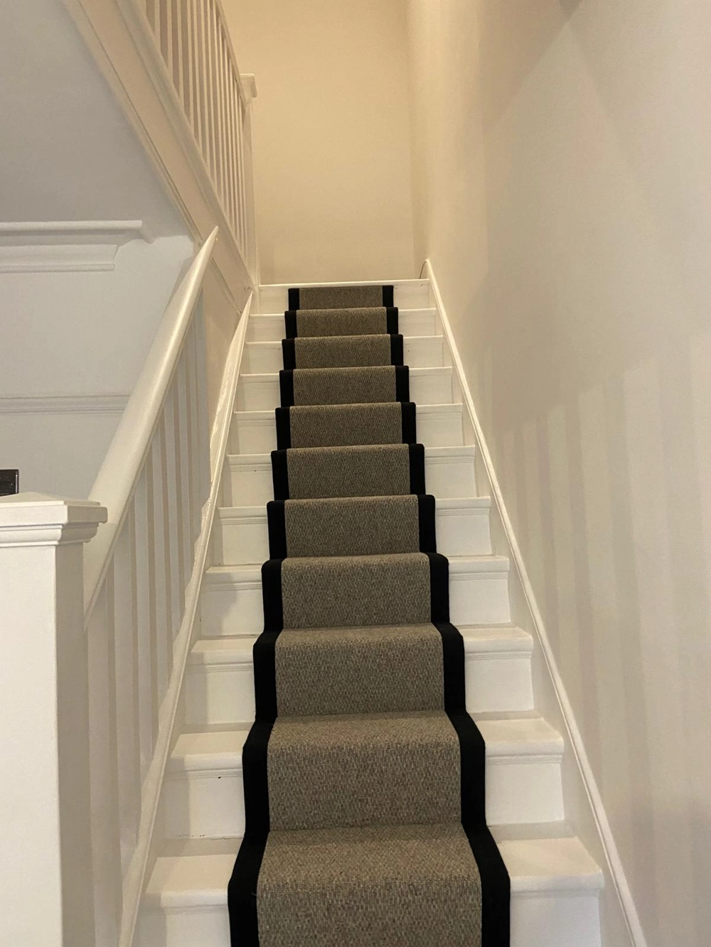 White wooden staircase with grey carpet runner edged in black, Flooring Installation