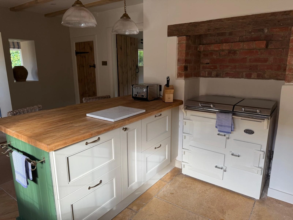 New kitchen island with wooden worktop, white cabinets and integrated storage, part of Kitchen Fitting