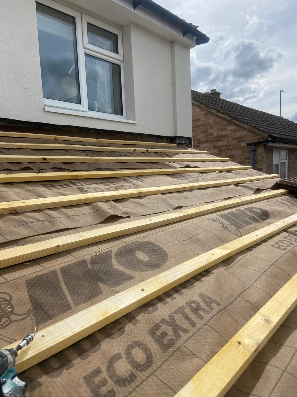 Roofing underlayment and battens installation on single storey extension roof