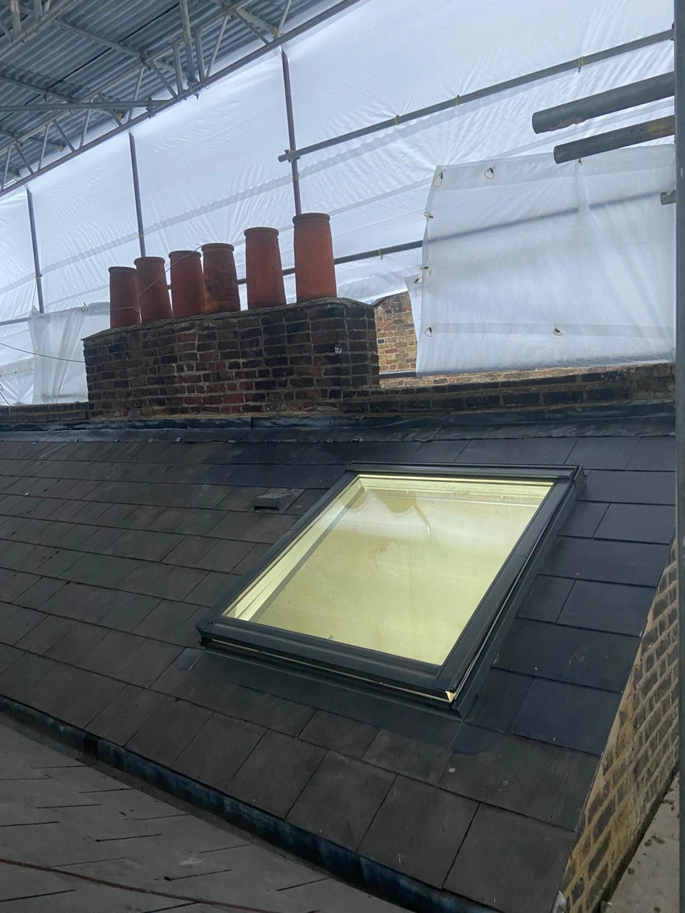 Slate roof with newly installed rooflight as part of loft conversion