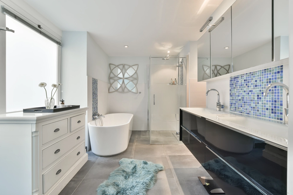 Bathroom Renovation: modern bathroom with freestanding bath, glass shower enclosure, mosaic tiled backsplash and double sink vanity