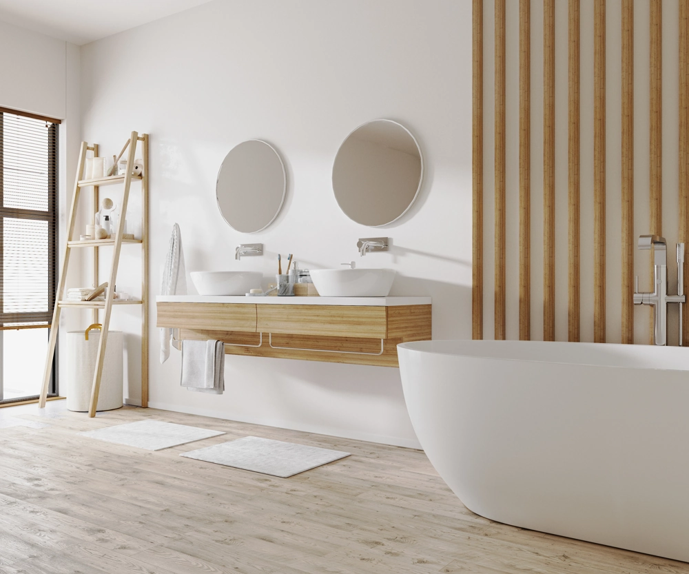 Modern bathroom renovation with freestanding tub, dual sinks, floating wooden vanity and ladder shelf
