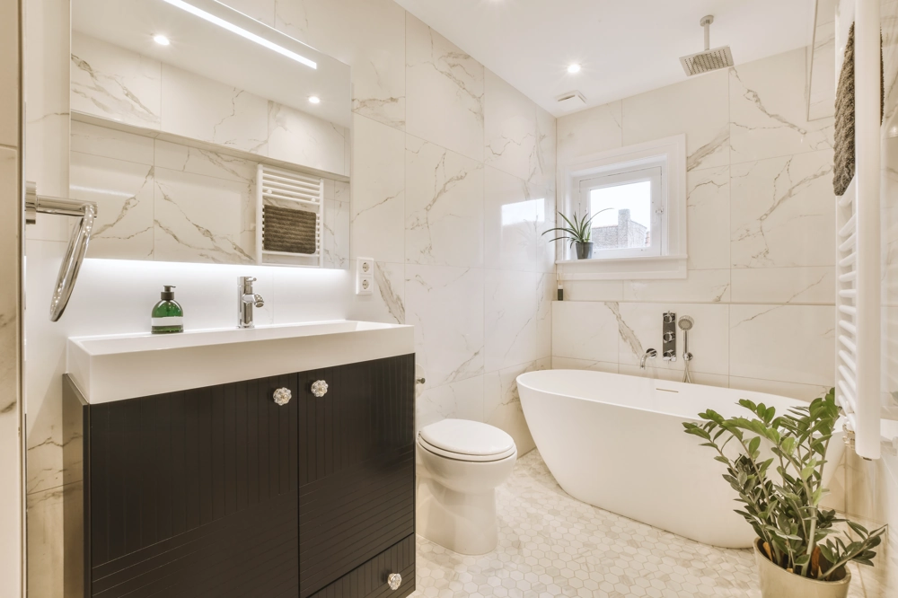 Bathroom Renovation: modern bathroom with marble-effect tiles, freestanding bath, vanity unit and rain shower