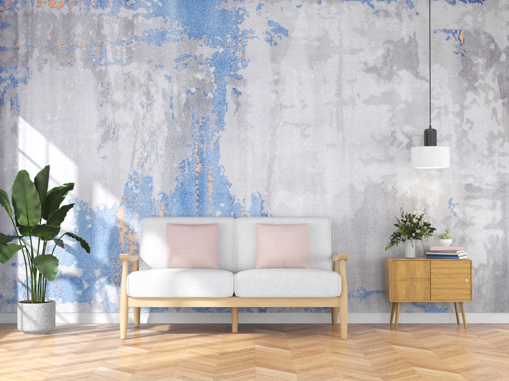 Living room with white sofa, pastel cushions, potted plant and herringbone wood flooring under a textured accent wall – Wood Flooring