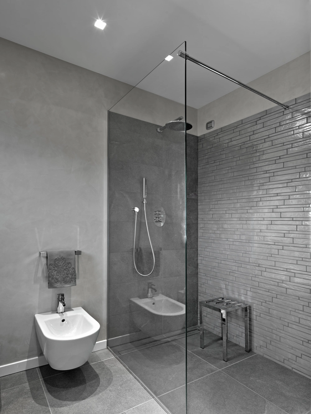 Tiled bathroom with walk-in glass shower enclosure and wall-mounted bidet, Bathroom Installation