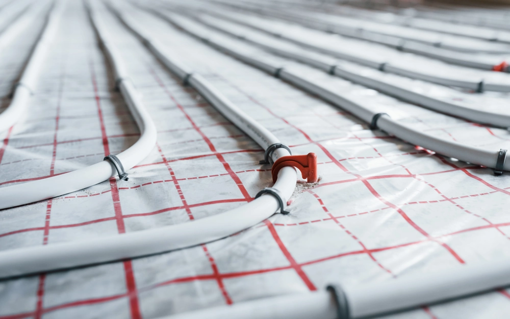 Underfloor heating pipes laid on grid-patterned insulation for Plumbing and Heating